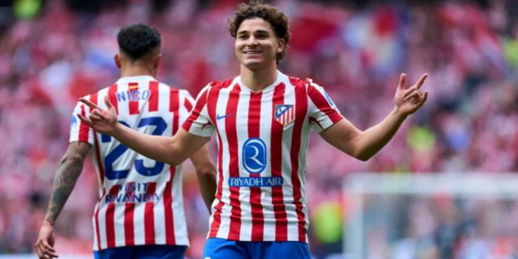 Julián Álvarez celebrando en el campo con los brazos levantados
