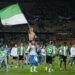 Afición del Real Betis con una bandera verdiblanca en el estadio.